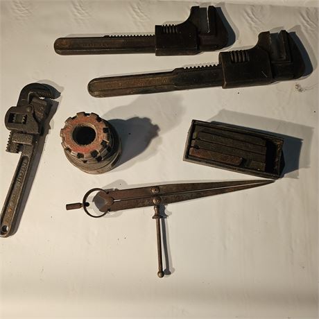 Collection Two large adjustable pipe wrenches, one smaller pipe wrench.