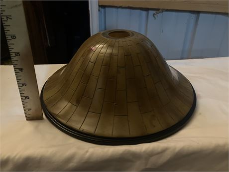 Lamp shade. It has a flared, conical shape  resembles wood planks.