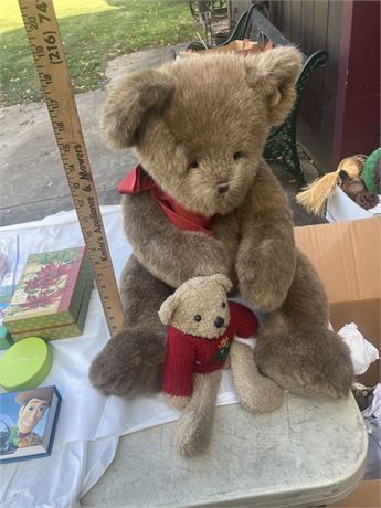 Two teddy bears, a large one and a smaller one,