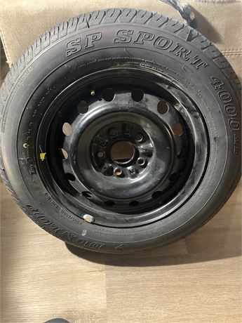 Tire size is P205/65R15. Dunlop SP Sport 4000 A/S tire mounted on a steel wheel,