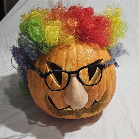 Jack-o'-lantern plastic smiling face and is decorated with a rainbow-colored cl