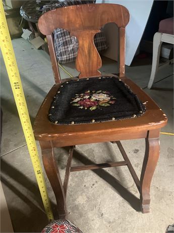 antique wooden chair with a needlepoint seat.