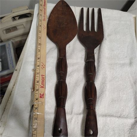 Set of large, carved wooden spoon and fork wall decor.