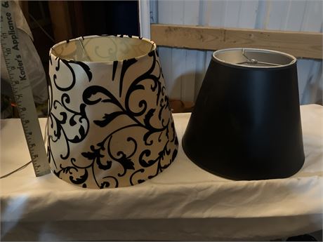 Set of two conical fabric lampshades, one with a black and white floral pattern
