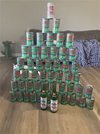 7-Up Bicentennial soda cans and bottles from 1976, arranged in a pyramid.