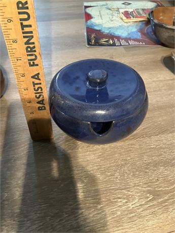 Cobalt blue, round ceramic lidded bowl with a small notch in the side, likely a