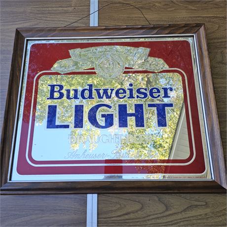 Budweiser mirrored sign in a wooden frame.