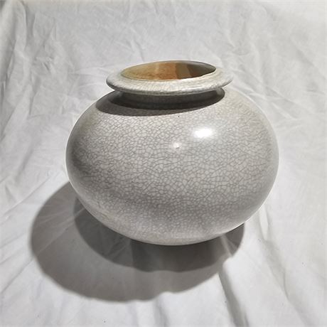 Lidded ceramic jar with a distinctive crackle glaze.