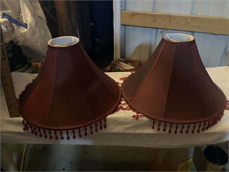 Pair of red fabric lamp shades with beaded fringe.