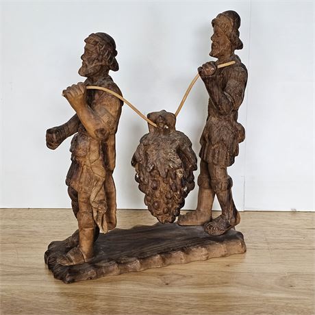 Hand carved wooden sculpture depicting Joshua &Caleb carrying grapes