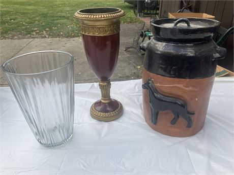 3 distinct decorative items: a clear glass fluted vase, a classical style red