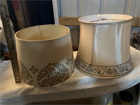 two decorative lampshades with different patterns. One has a floral pattern sten