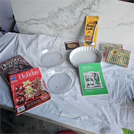 collection of items, including a new gravy ladle in its original packaging, a wh
