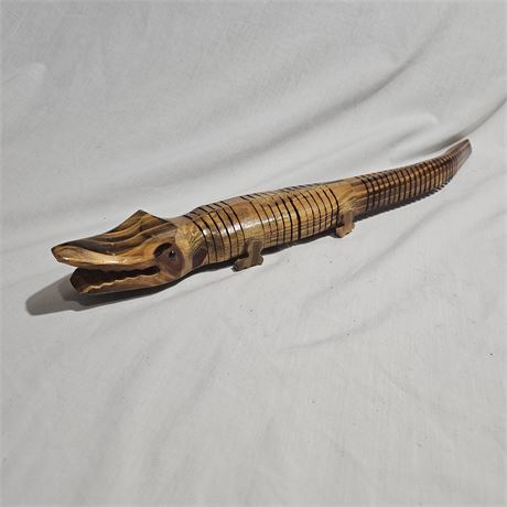 Handcrafted, articulated wooden crocodile or alligator toy.