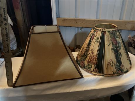 Two lamp shades (one tan, one green/white/flor