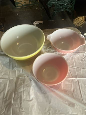 Set of vintage Pyrex mixing bowls. The set includes a large yellow bowl and two