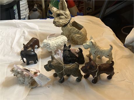 collection of vintage and antique cast-iron dog figurines, many of which are Sc