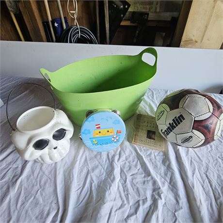 Franklin soccer ball, a small book, a small tin with a boat design, and a white