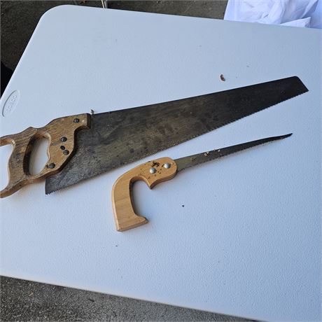 Two vintage hand saws: a large hand saw  and a smaller keyhole saw