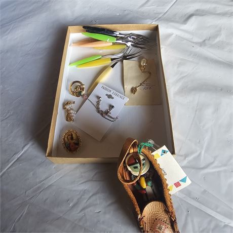 collection of assorted jewelry and a small, decorative,  Native American-style m