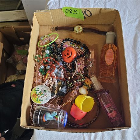 Variety of items, including jewelry, a watch, and two bottles of perfume.