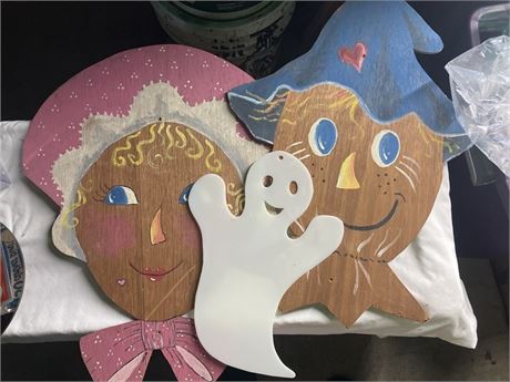 two hand-painted wooden cutouts depicting folk art characters