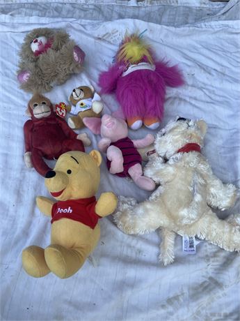 Assortment stuffed animals, including several Winnie the Pooh characters