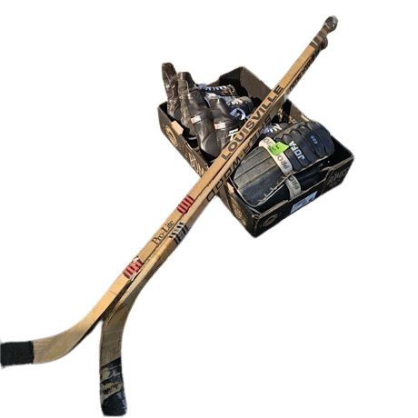 Collection of vintage ice hockey equipment, including two hockey sticks, a pair