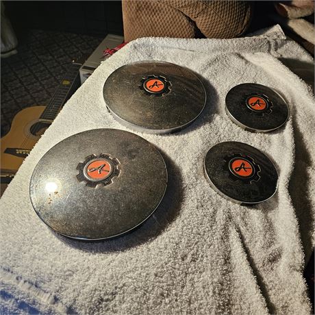 Four Ariens hubcaps.