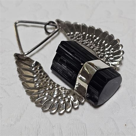 Silver winged with black onyx pendant representing