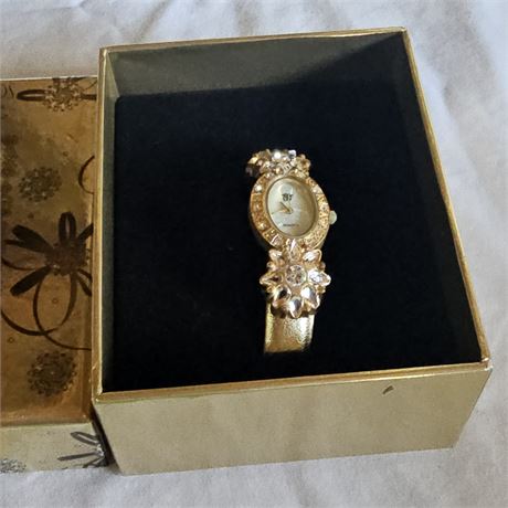 Elizabeth Taylor White Diamonds floral rhinestone gold-tone watch.