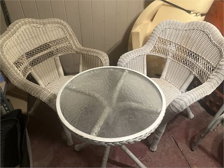 White wicker patio dining set with a glass-top table and two chairs.