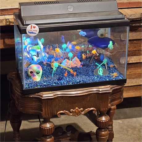 Aquarium, decorated with various items to house fish and other aquatic life. Bl