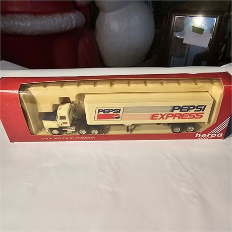 Herpa Pepsi Express semi-truck with a trailer, which is a die-cast model.