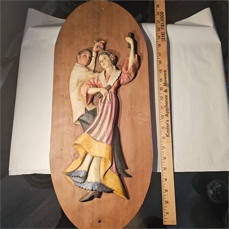 Wooden wall hanging that depicts a dancing couple