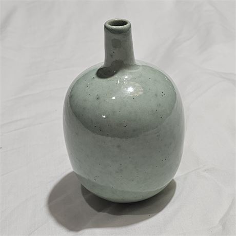 Vintage green bud vase, likely made of clay /stoneware with the markings "ADLER