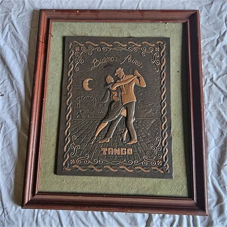 Vintage-style repoussé artwork depicting two people dancing the tango.