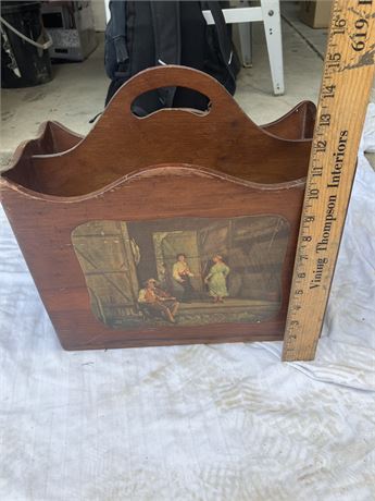 Vntage wooden magazine rack featuring a colonial-era scene
