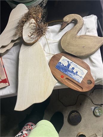 Several decorative wooden items, including a carved wooden swan and a wooden ang