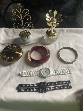 Collection of assorted jewelry and watches, including a white watch, a black wa