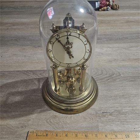 Anniversary clock with a glass dome.