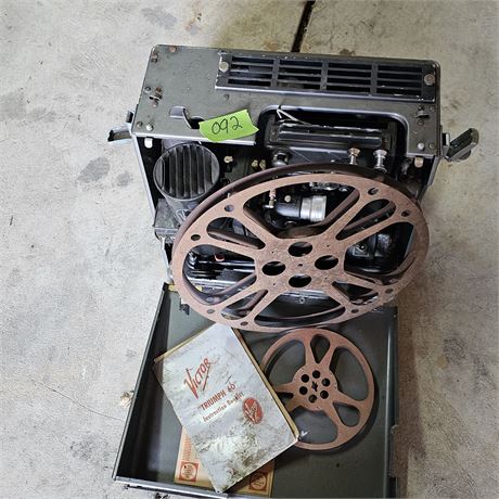 Vintage Victor "Triumph 60" 16mm movie projector and its instruction booklet.