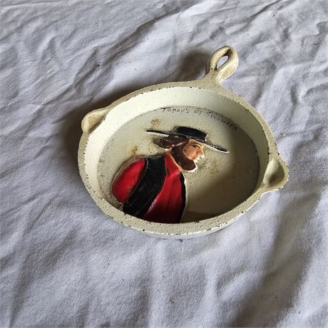 Vintage, miniature cast iron skillet that serves as a decorative item,