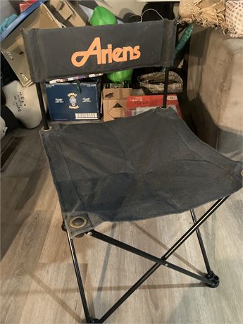 Black folding chair with the "Ariens" logo on the backrest.
