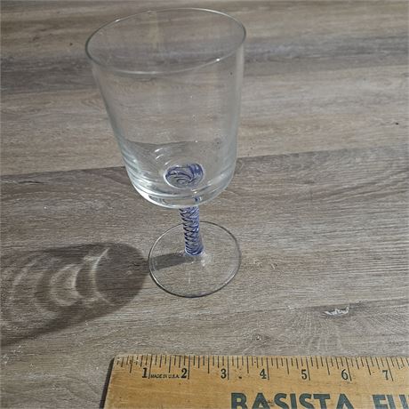 vintage glass champagne flute with a blue swirl stem.