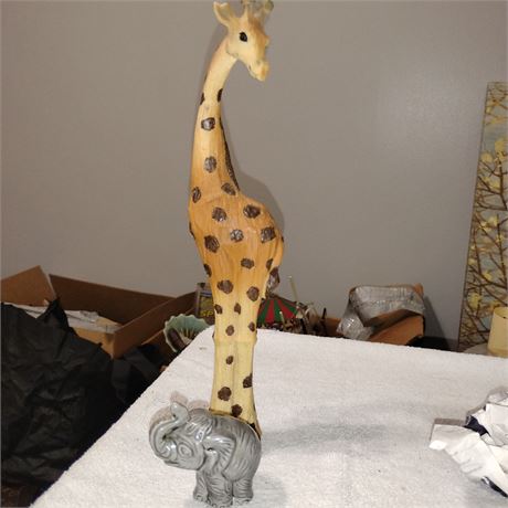 Vintage safari-themed sculpture a giraffe and an elephant.